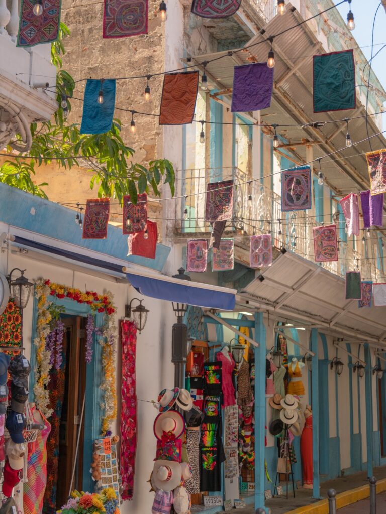 Colorful molas and woven textiles hanging overhead in La Calle de Las Molas alley, Casco Viejo Panama