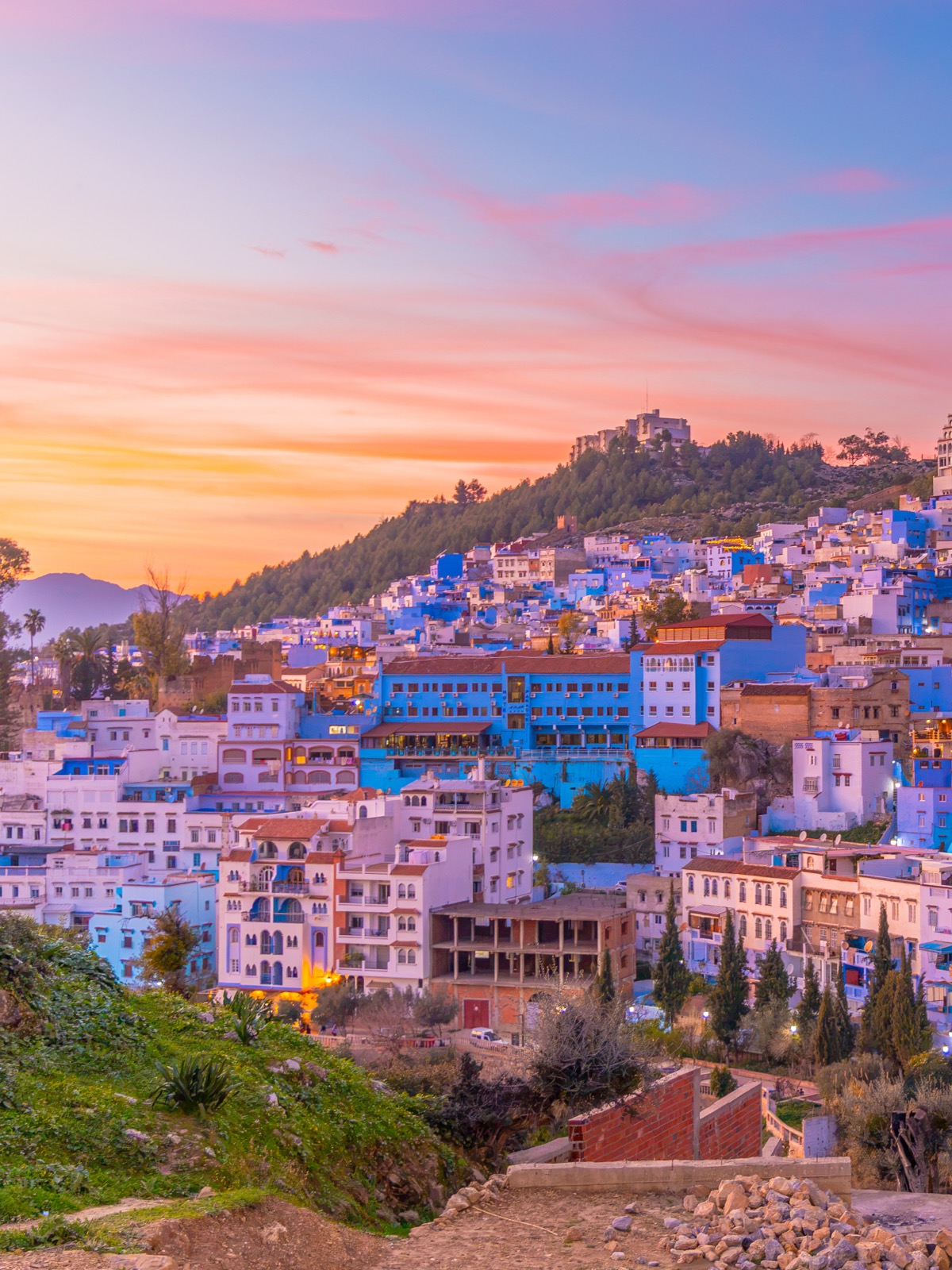 Panoramic sunset view of Chefchaouen’s blue medina and surrounding hills