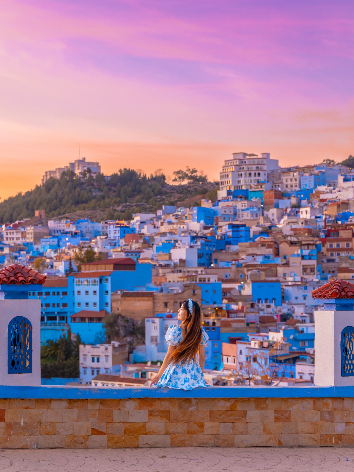 Amy overlooking the blue houses of Chefchaouen at sunset