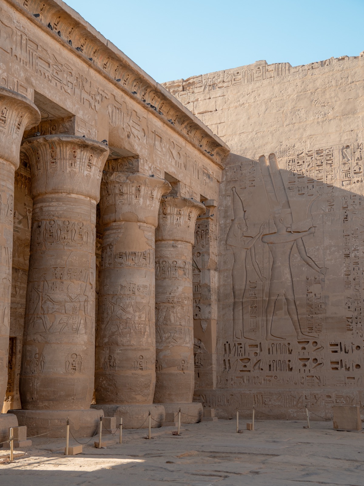 Courtyard columns and carved reliefs at Medinet Habu in Luxor