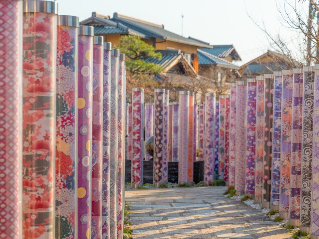 Close-up of colorful kyo-yuzen dyed fabric pillars at the Kimono Forest in Arashiyama, Kyoto