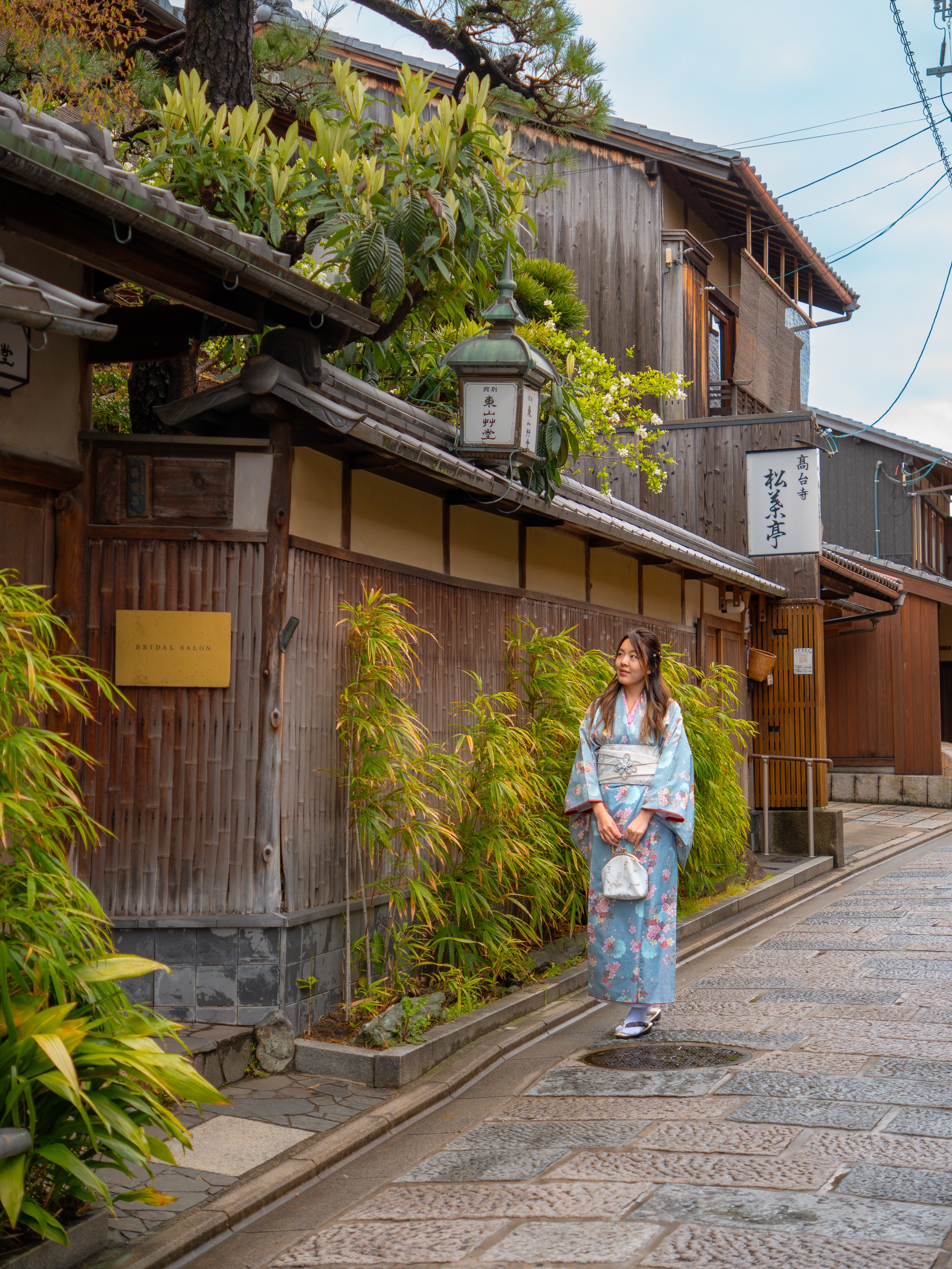 Woman in kimono walking along Sannenzaka, a stone-paved traditional street in Kyoto Higashiyama district