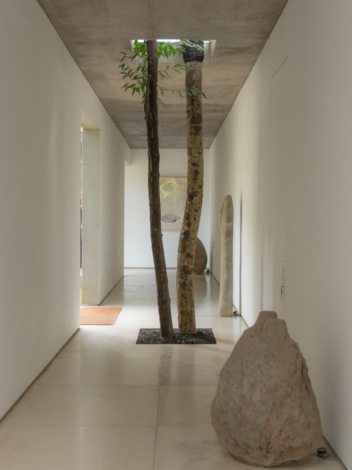 Concrete hallway and trees at Lodge in the Woods in Bali