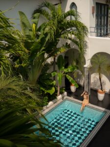 Tropical hotel courtyard in Nicaragua with checkered turquoise pool and palm trees