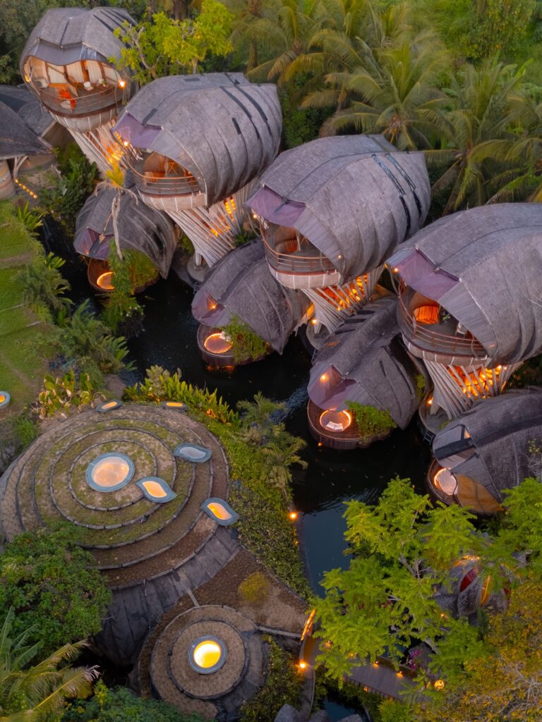 Aerial drone view of the curving bamboo villas and river at Ulaman Eco Luxury Resort in Bali, Indonesia